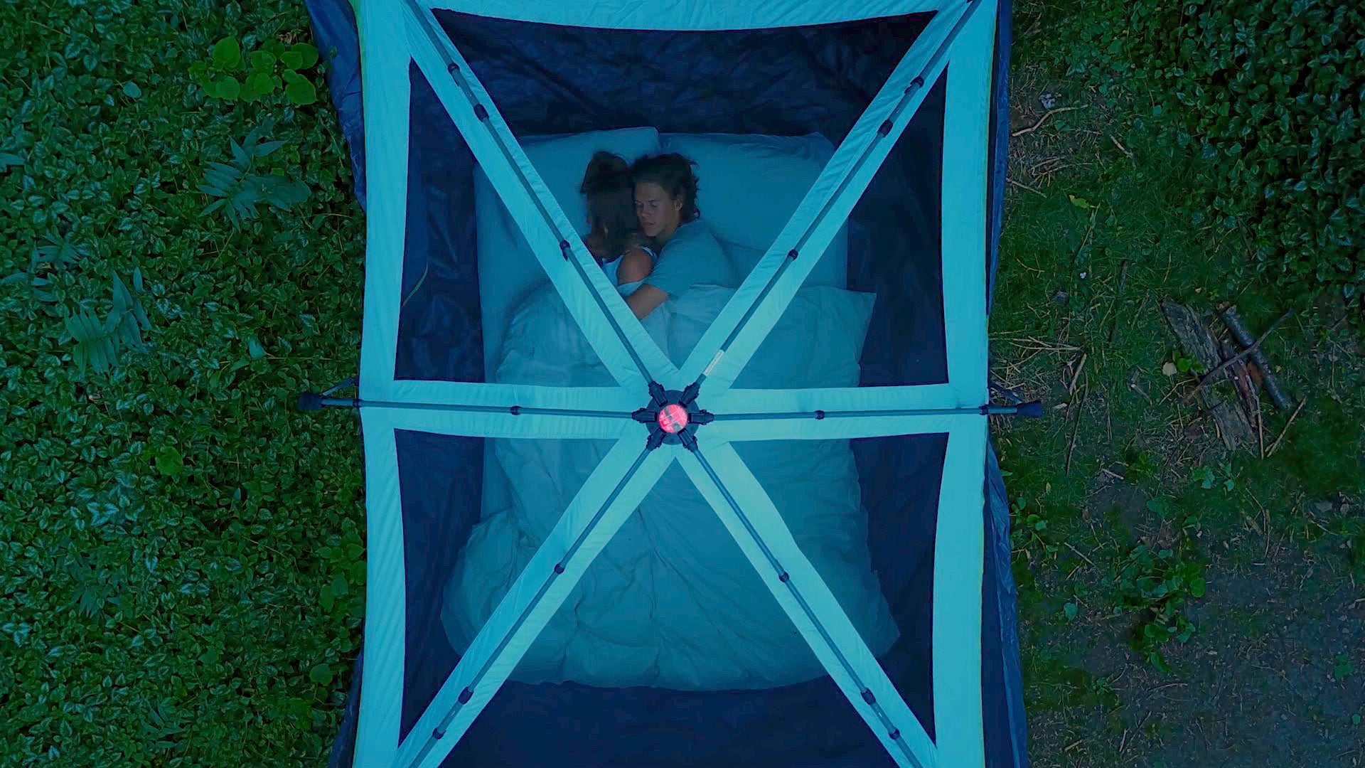 Couple sleeping on twilight thermal mattress topper in tent
